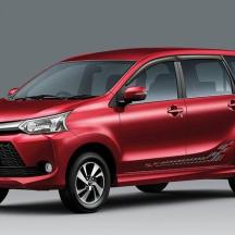 a red toyota parked on a blue background