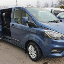 a blue van parked in a parking lot