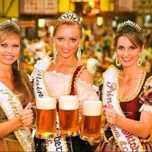 three women holding beer mugs in a bar