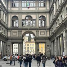 a group of people walking around a large building