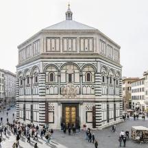 a large building with people walking in front of it
