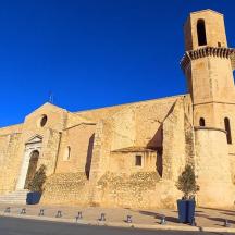 a large stone church with a tower on a street