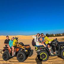 a group of people riding on atvs in the desert