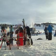 eine Gruppe von Menschen steht mit Skiern im Schnee
