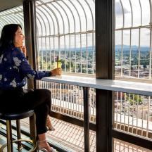 two women sitting at a bar in a building with a view