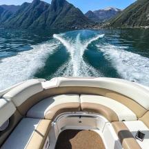 a boat on a body of water with mountains