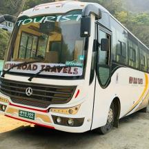 a white bus parked on a dirt road