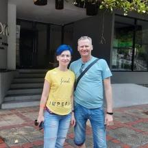 a man and a woman standing in front of a building