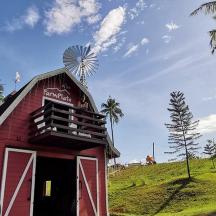 a red barn with a windmill on top of it