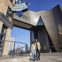 a man and woman standing in front of a building