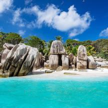 a group of large rocks on a beach
