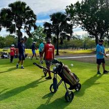 a group of people playing golf in a park
