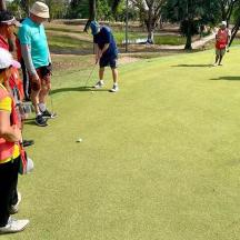 a group of people playing a game of golf