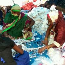 a group of women sitting on a blanket