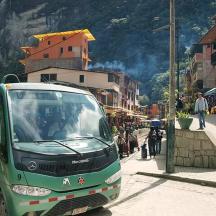 a green bus is parked on a city street