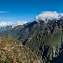 an aerial view of a mountain with smoke on it