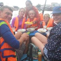 a group of people in life jackets on a boat