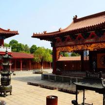 an asian building with a gate in a courtyard