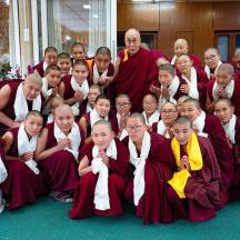 a group of monks in red robes posing for a picture
