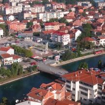 an aerial view of a city with a river and buildings