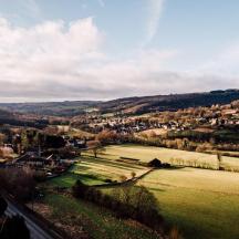 a view of a small town in a green field