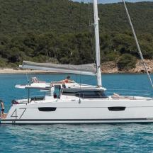 a couple of people on a sail boat in the water