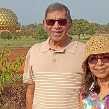 a man and a woman standing in front of a building