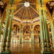 a large building with columns and a clock on the ceiling