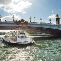 a boat in the water under a bridge