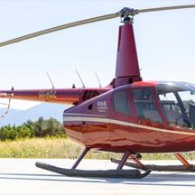 a red helicopter is parked on a runway