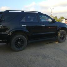 a black truck parked in a parking lot