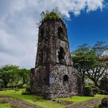 an old stone tower in the middle of a field
