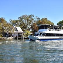 a boat on the water next to a house