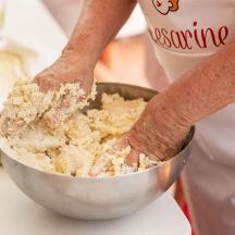 a person mixing food in a bowl on a counter