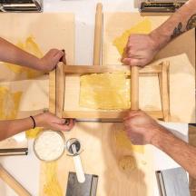 two people holding a wooden box on a cutting board