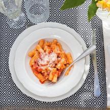 a plate of pasta on a table with a fork