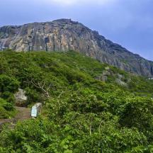 a rocky mountain with stairs and a mountain