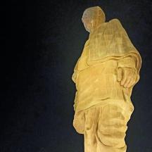 a statue of a man is wrapped in plastic