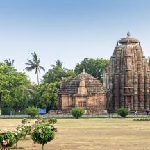 a temple in a park with trees and flowers