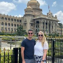 a man and woman standing in front of a building