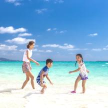 a group of children playing on the beach