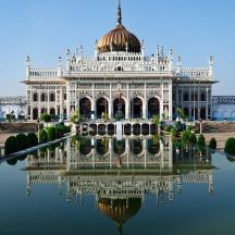 a large building with a reflection in the water