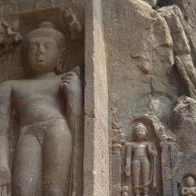 a stone statue on the side of a wall