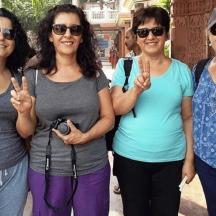 a group of women standing together with their hands up