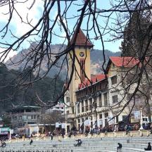 a large building with a clock tower in a town