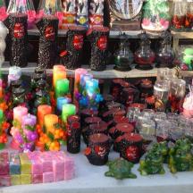 a display of different colored glass vases on a table