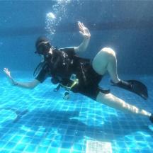 a woman is swimming in a pool of water