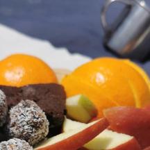 a plate of food with fruit on a table