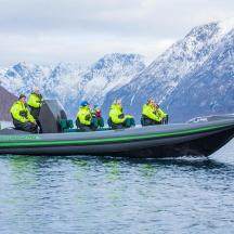 a group of people in a boat on the water