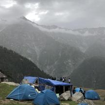 a group of tents pitched on top of a mountain